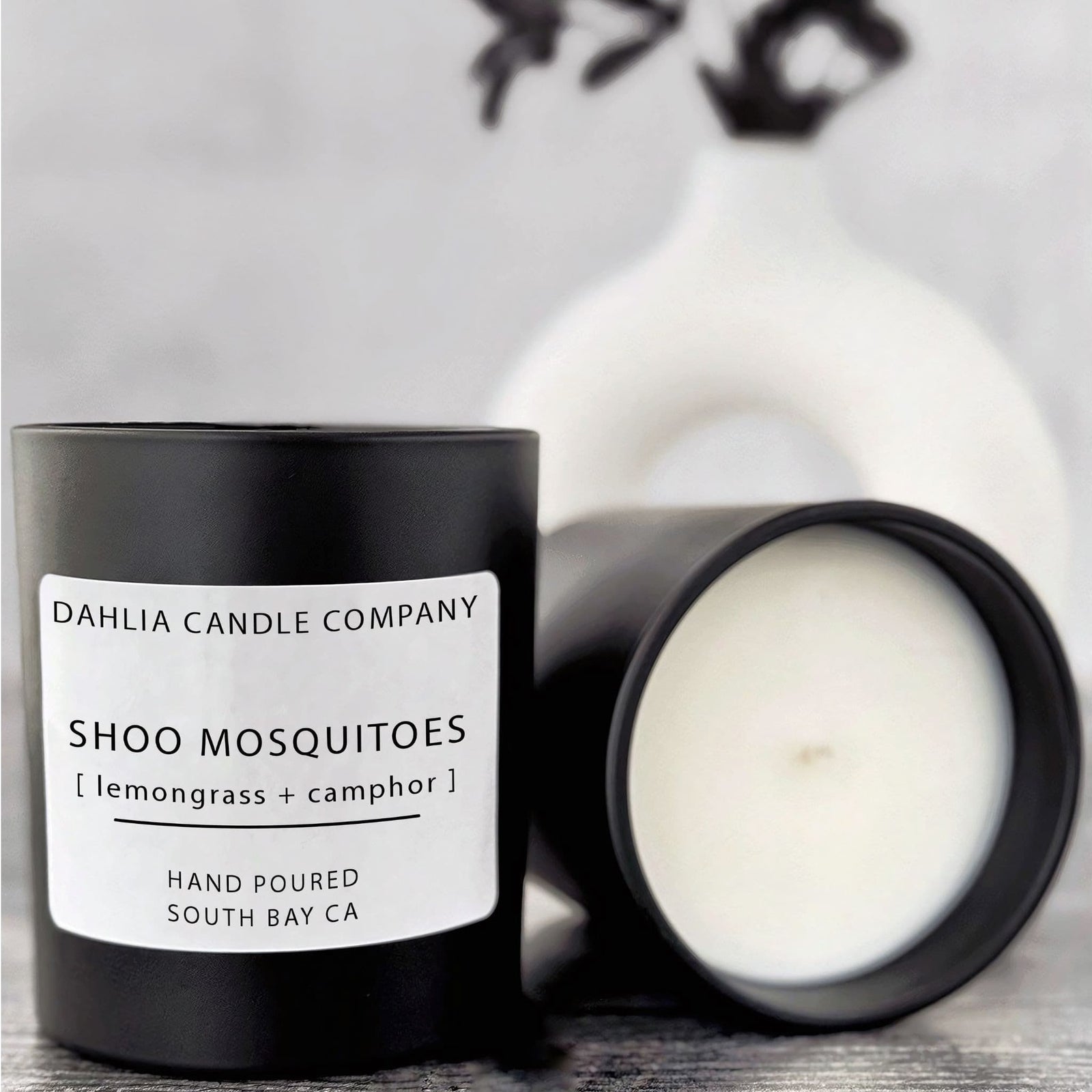 Shoo Mosquitoes candle with refreshing lemongrass and natural camphor, crafted to help repel bugs with a clean herbal scent.